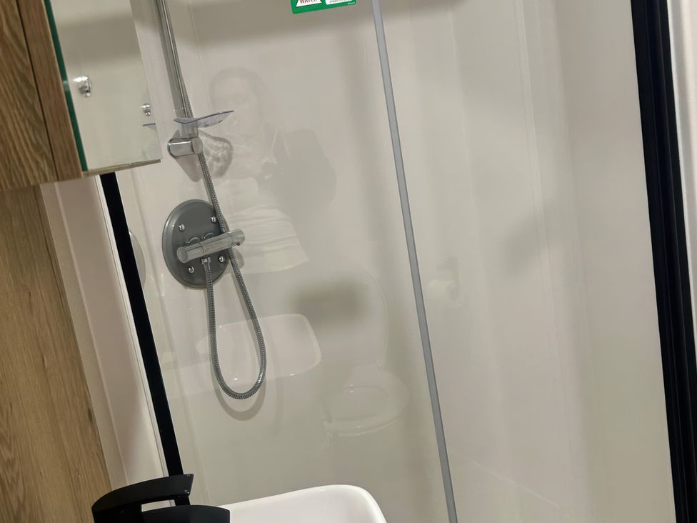 A bathroom with a shower and toilet at 