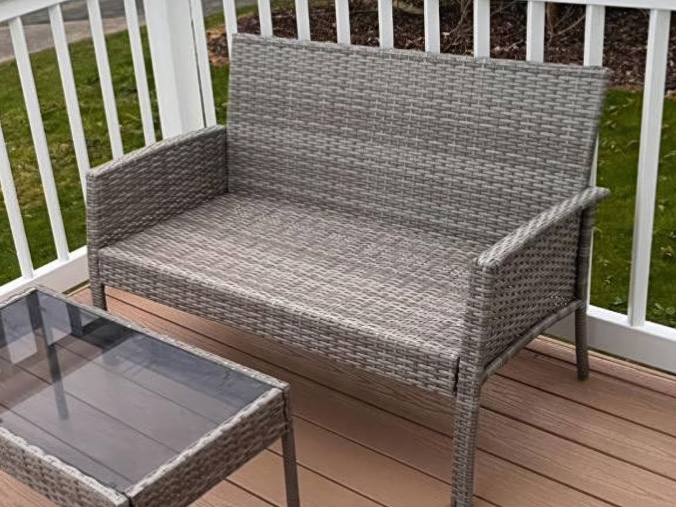 A bench and table on a deck at 