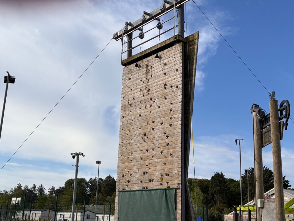 A climbing wall with safety equipment in an outdoor area