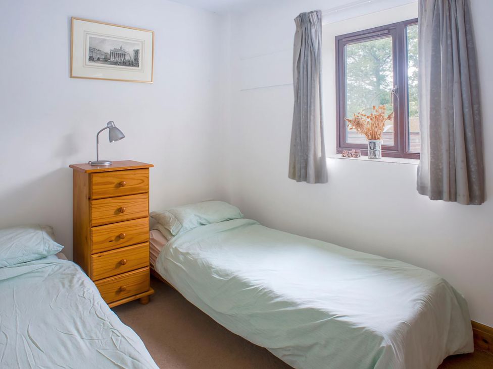 A bedroom with two single beds and a wooden drawer at Accessible 4-Bed Barn, Sleeps 8 - Farm Stay, The Games Barn near Mayfield