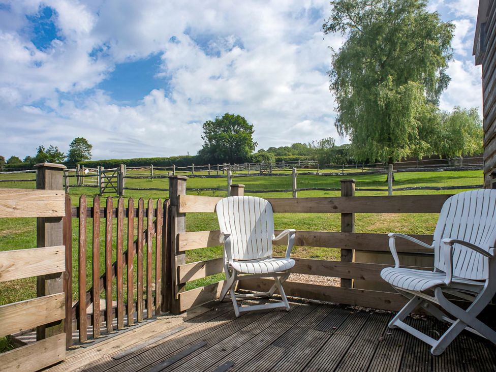 An outdoor area with chairs and a gate at Accessible 4-Bed Barn, Sleeps 8 - Farm Stay near Mayfield