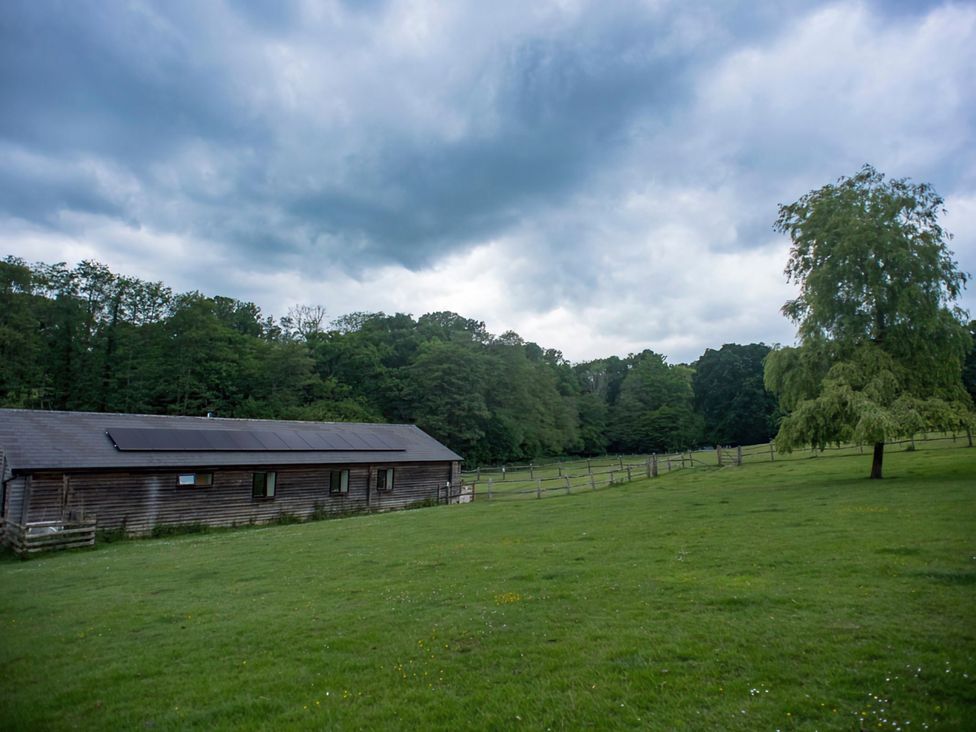 A barn surrounded by grass and trees at Accessible 4-Bed Barn, Sleeps 8 - Farm Stay The Games Barn near Mayfield