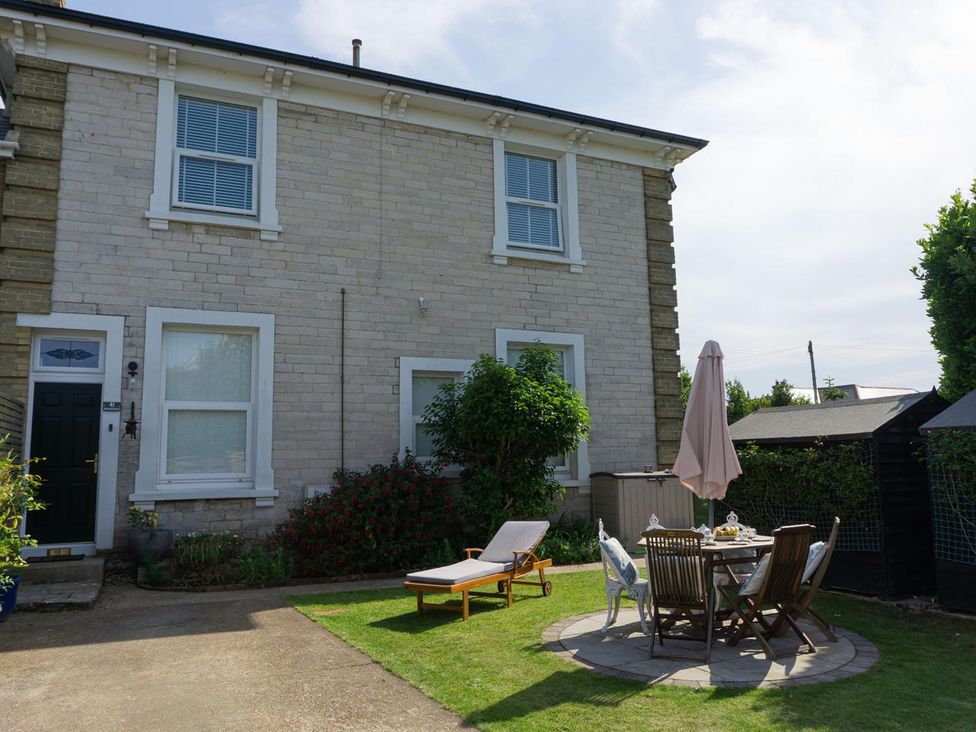 A garden with seating and a table at Lovely, spacious apartment - sleeps 5 in Ryde