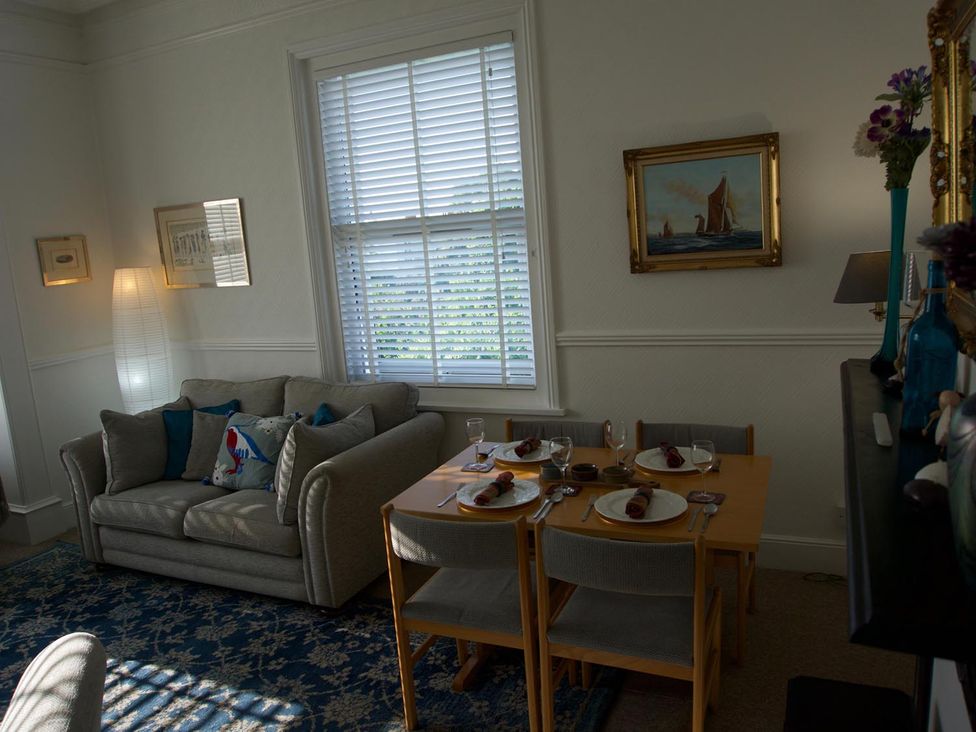 A dining room with a table set for a meal at Lovely, spacious apartment - sleeps 5 in Ryde