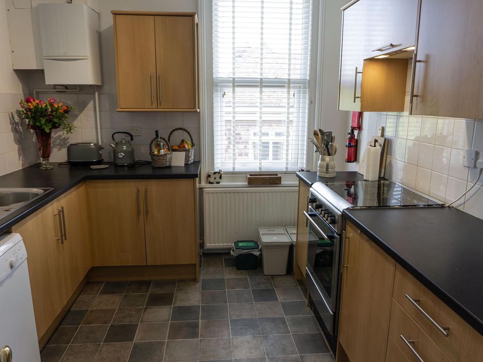 A kitchen with cabinets and appliances at Lovely, spacious apartment - sleeps 5 in Ryde