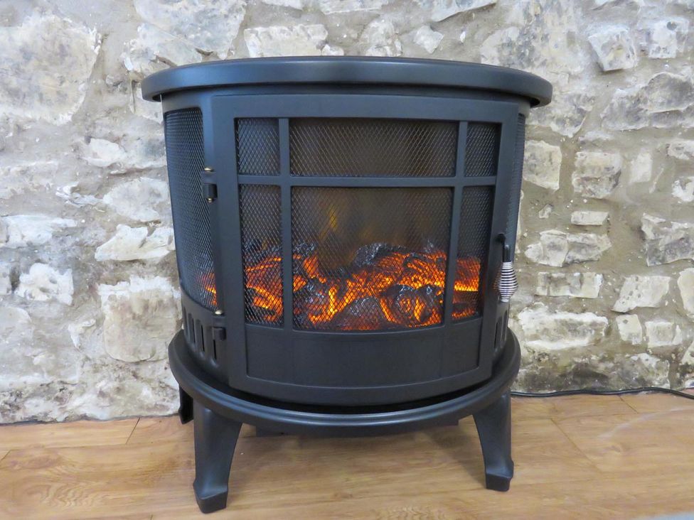 An electric stove with ember effect at Vale of Glamorgan - Cottage - Sleeps 4 - Parking in Llancarfan near St Athan
