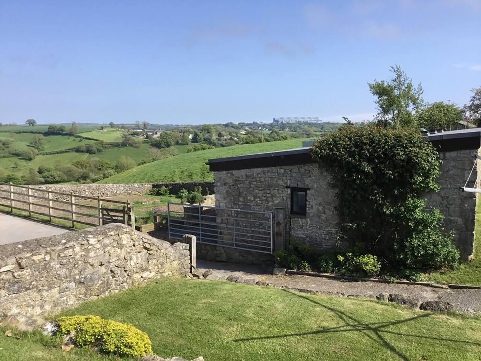 A stone building with a gate and fence in a landscape at Vale of Glamorgan - Cottage - Sleeps 4 - Parking Llancarfan near St Athan
