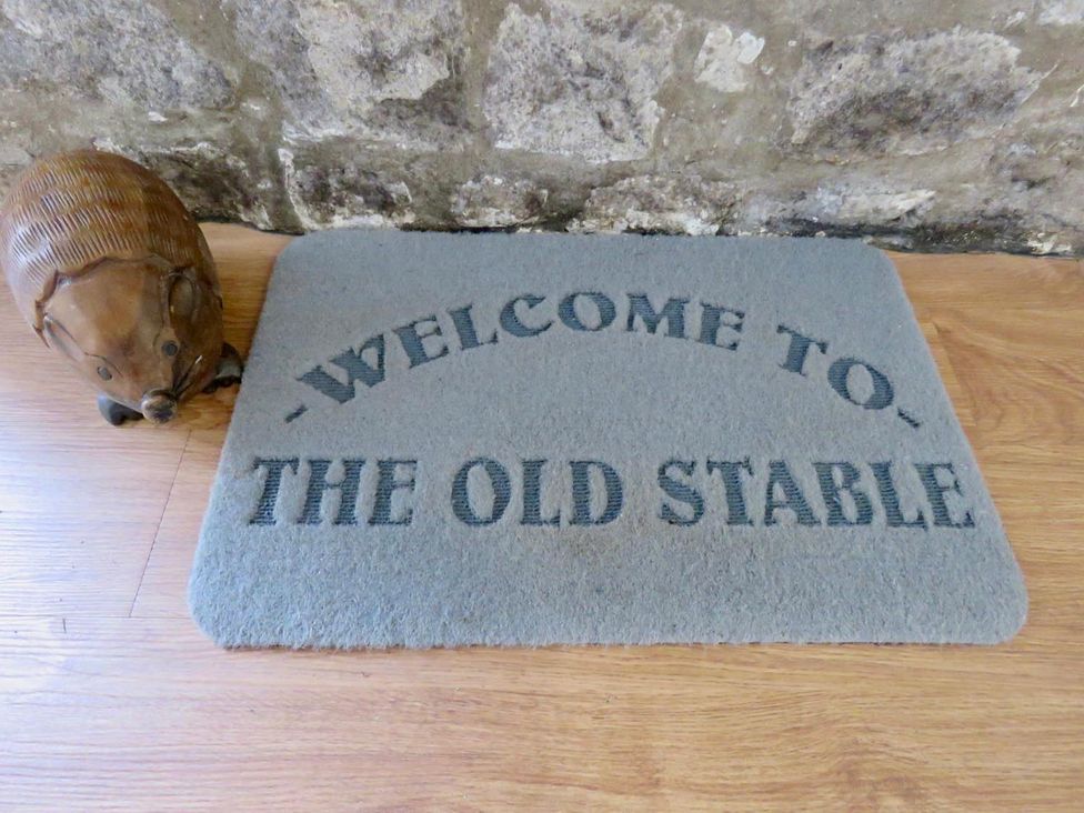 A doormat and wooden animal figurine in The Old Stable in Llancarfan near St Athan
