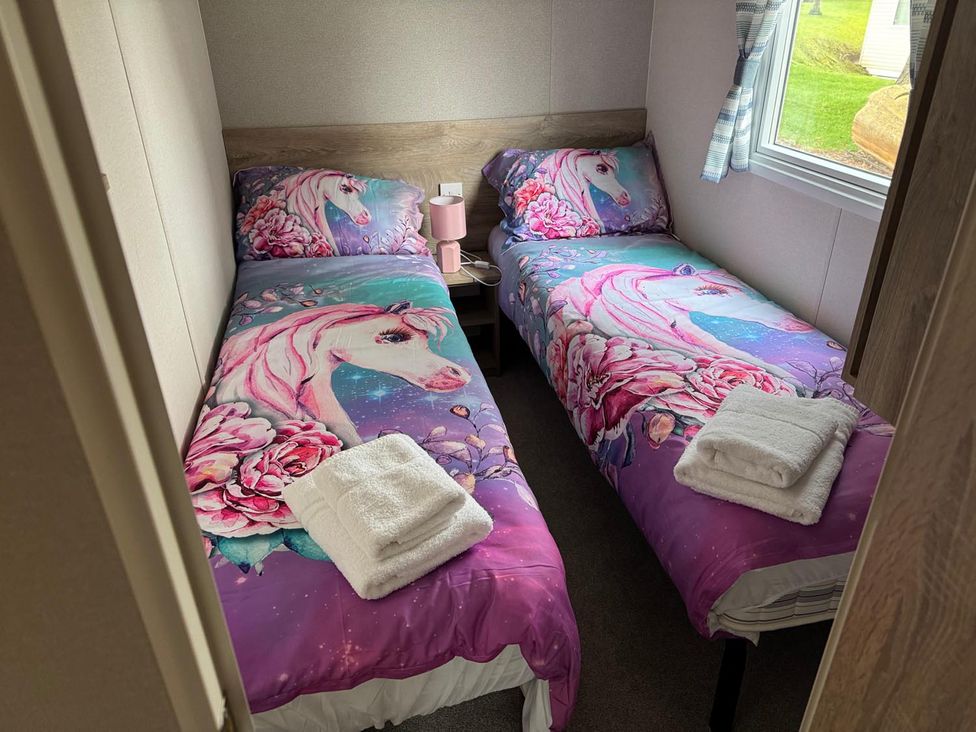 A bedroom with two single beds and a nightstand at West Lawn 47 Haggerston Castle Paddock Views Haggerston