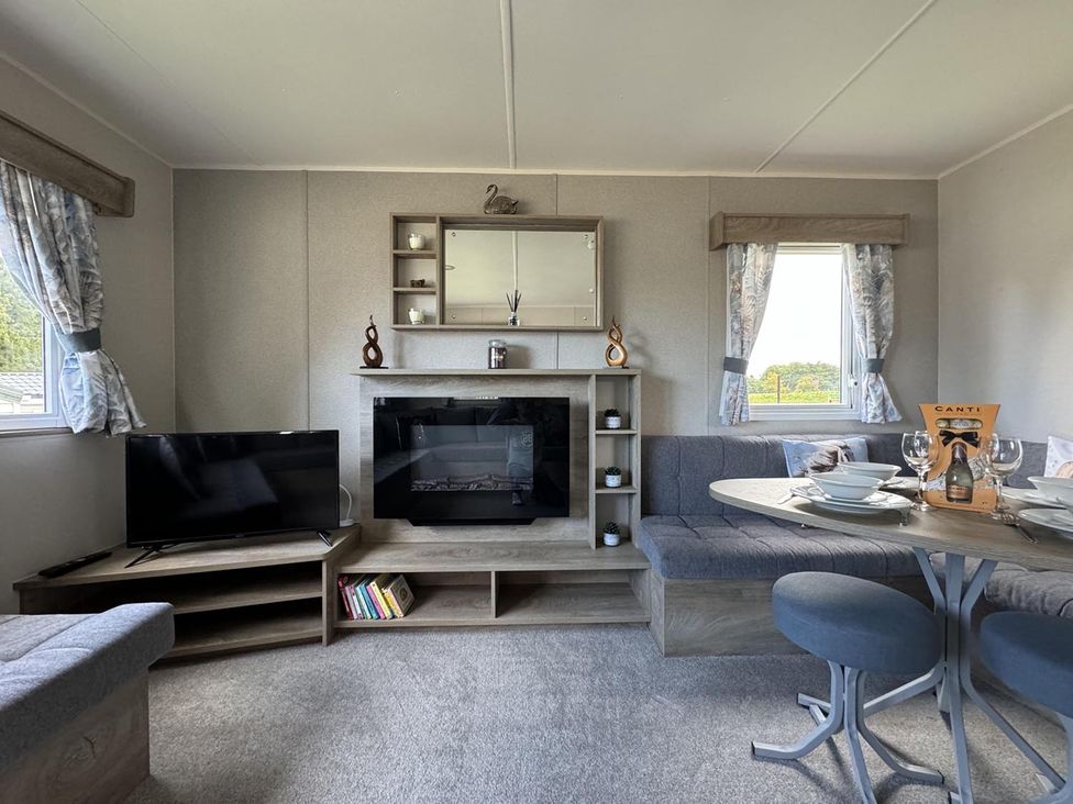 A living room with a sofa and television at West Lawn 47 Haggerston Castle Paddock Views Haggerston
