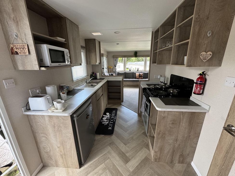 A kitchen with appliances and storage at West Lawn 47 Haggerston Castle Paddock Views Haggerston