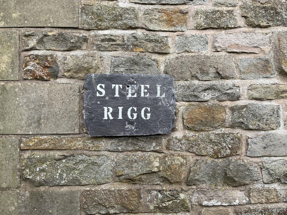 A nameplate saying STEEL RIGG on a stone wall at Milecastle Inn on Hadrian's Wall near Haltwhistle