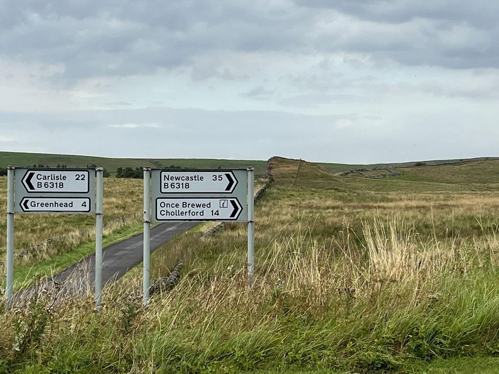 A directional sign on a road in a field near Milecastle Inn on Hadrian's Wall near Haltwhistle