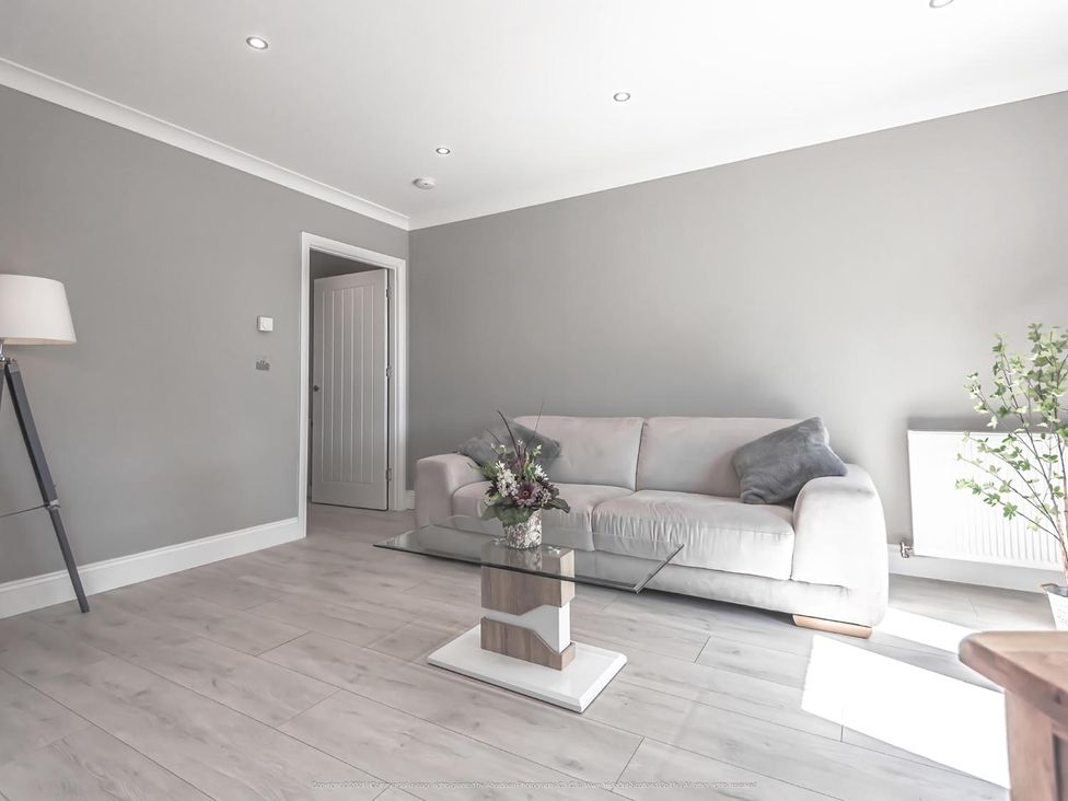 A living room with a sofa and coffee table at 1 Bed Cottage-Sleeps 2-Parking-Pets-Hot Tub in Kelty