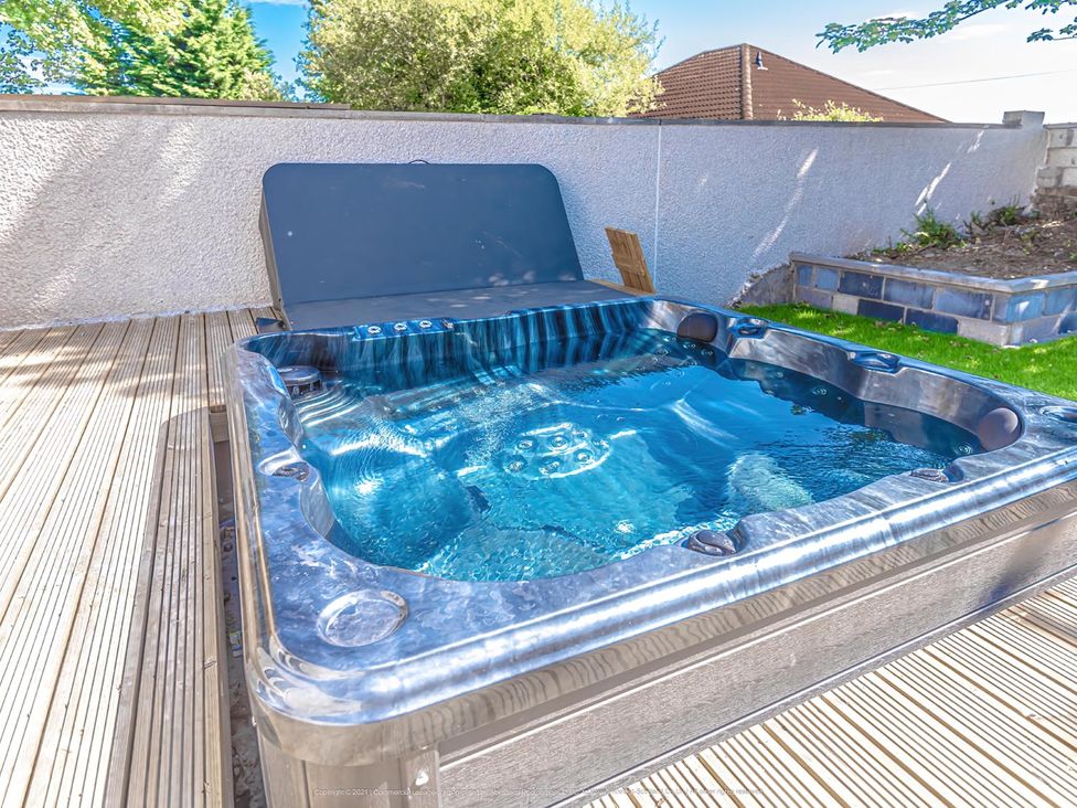 A hot tub on decking in an outdoor area at 1 Bed Cottage-Sleeps 2-Parking-Pets-Hot Tub in Kelty