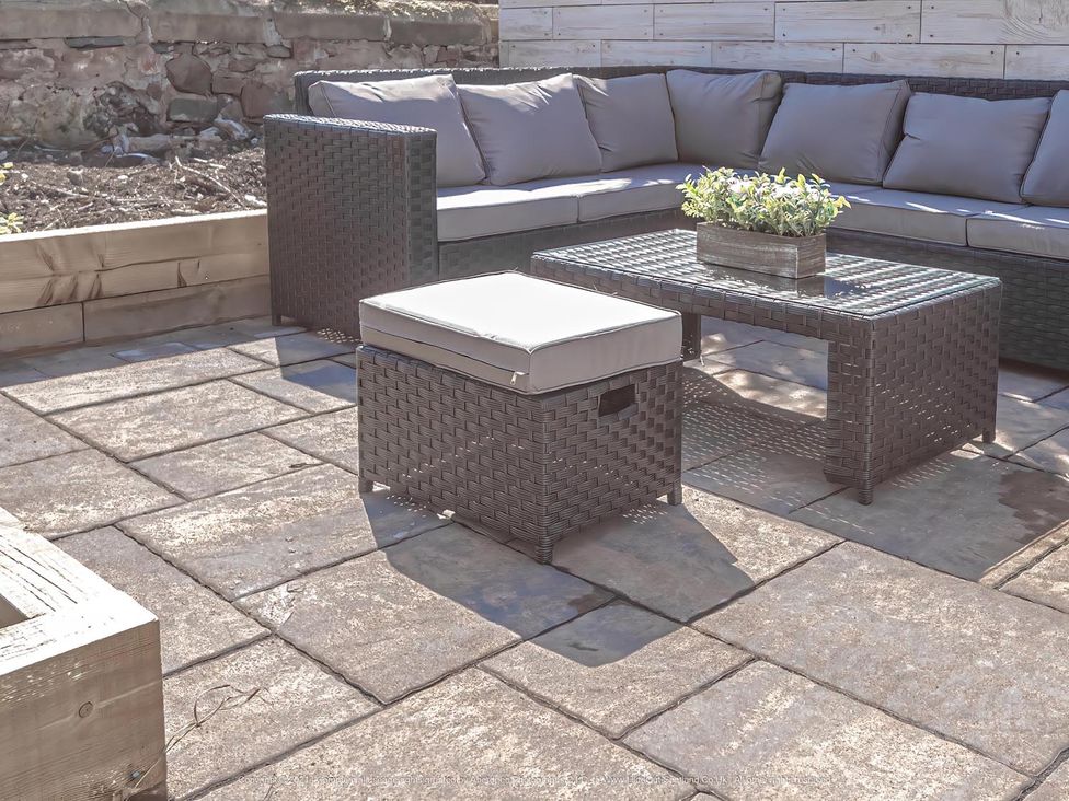 A patio area with seating and a table at 1 Bed Cottage-Sleeps 2-Parking-Pets-Hot Tub in Kelty