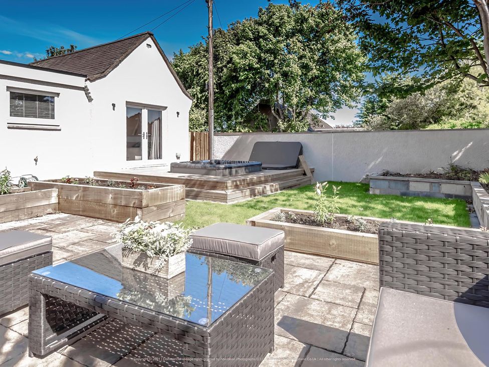 A garden with planting boxes and a hot tub at 1 Bed Cottage-Sleeps 2-Parking-Pets-Hot Tub, Kelty