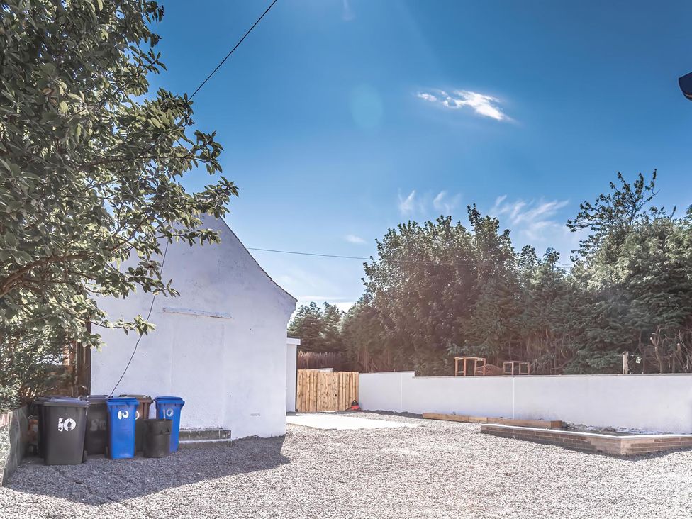 An outdoor area with gravel and bins at 1 Bed Cottage-Sleeps 2-Parking-Pets-Hot Tub in Kelty