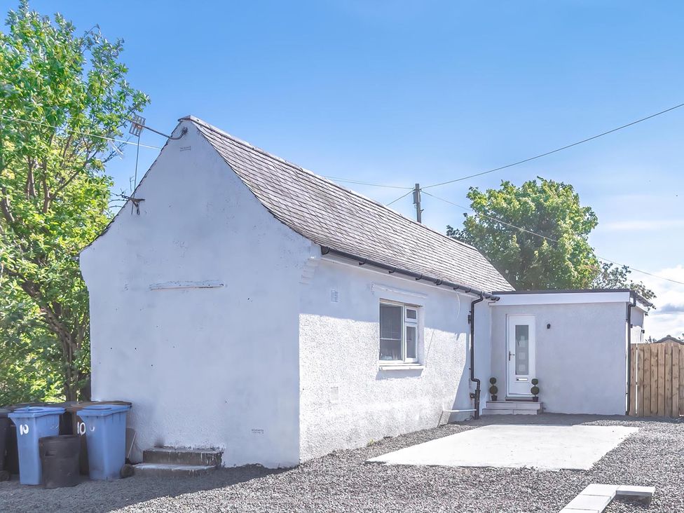 A house with a door and trash bins at 1 Bed Cottage-Sleeps 2-Parking-Pets-Hot Tub, Kelty