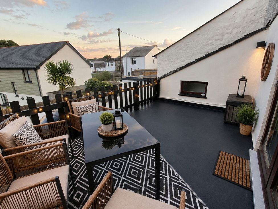An outdoor terrace with seating and a table at Stylish Cornish Retreat, Sleeps 4 Near Hayle Beach in Hayle