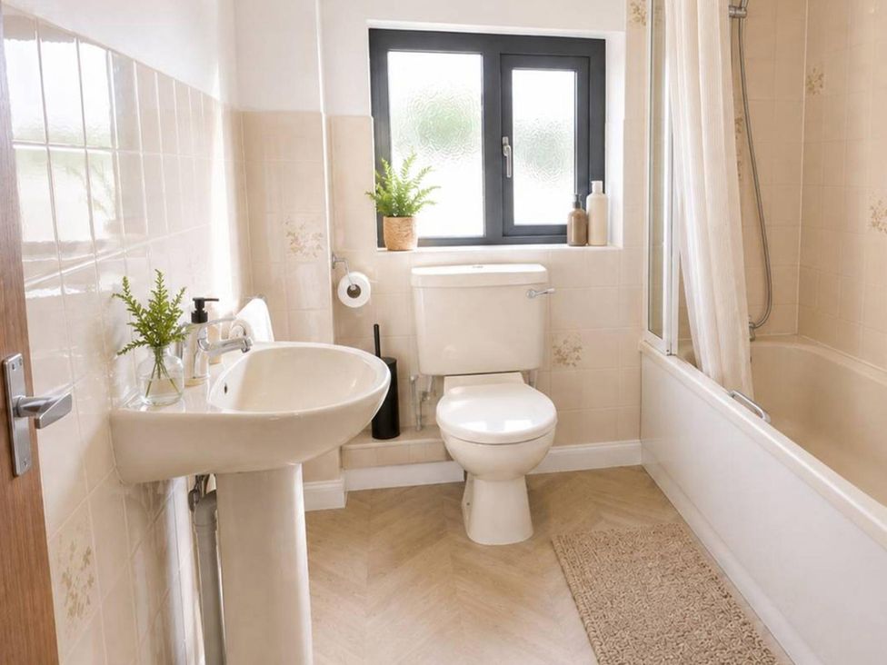 A bathroom featuring a sink, toilet, bathtub, and shower at Stylish Cornish Retreat, Sleeps 4 Near Hayle Beach, Hayle