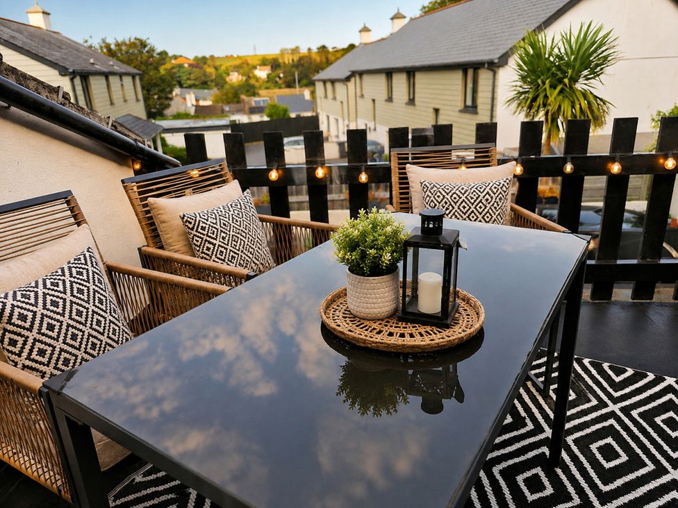 An outdoor seating area with table and chairs at Stylish Cornish Retreat, Sleeps 4 Near Hayle Beach, Hayle