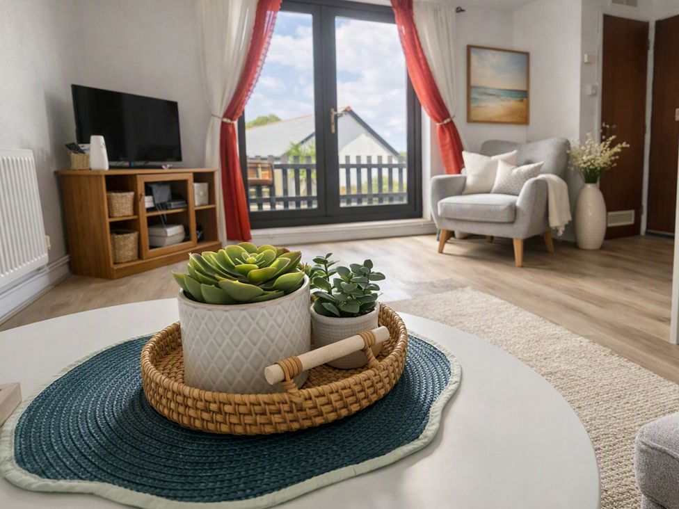 A living room with a television and a coffee table at Stylish Cornish Retreat, Sleeps 4 Near Hayle Beach, Hayle