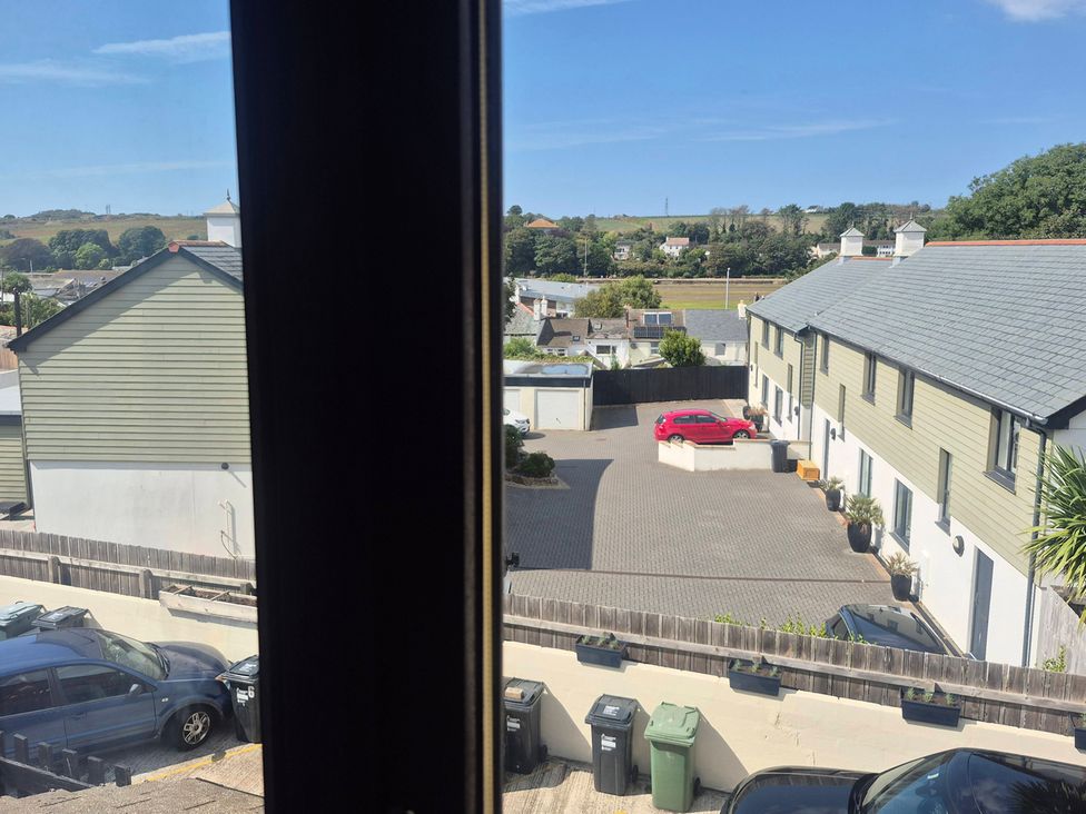 View of houses and a parking lot from a window at Stylish Cornish Retreat, Sleeps 4 Near Hayle Beach, Hayle