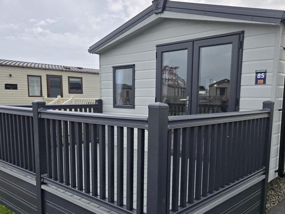 A cabin exterior with a deck at 3 Bedroom Cabin Sleeps 6 - Shared Pool & Shared Hot Tub, Flamingo Land Resort near Malton