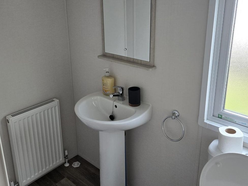 A bathroom with sink and toilet at 3 Bedroom Cabin Sleeps 6 - Shared Pool & Shared Hot Tub
