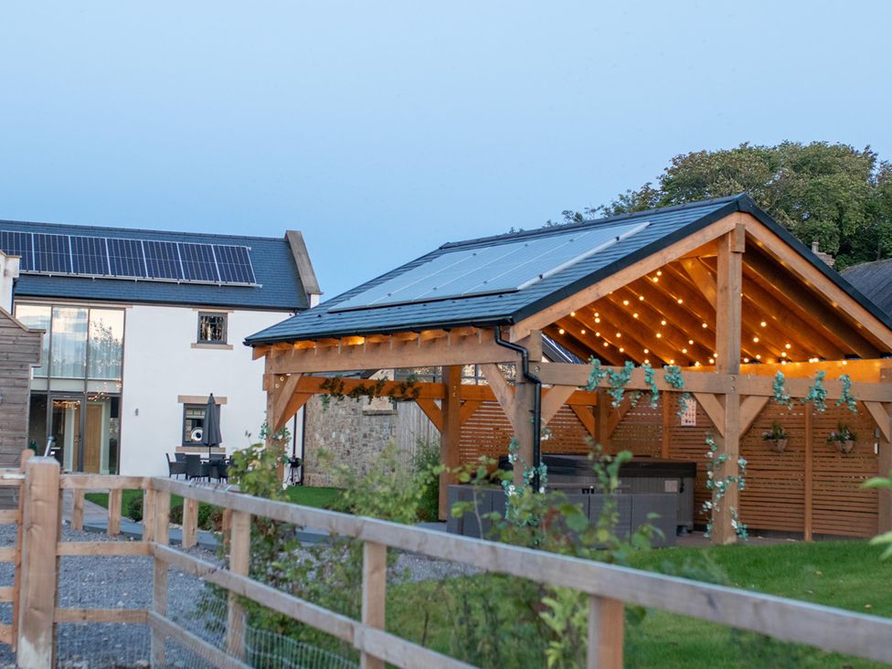 An outdoor area with a house and shelter featuring solar panels at Northumberland Luxury Stays - The Chivits West Chevington near Amble