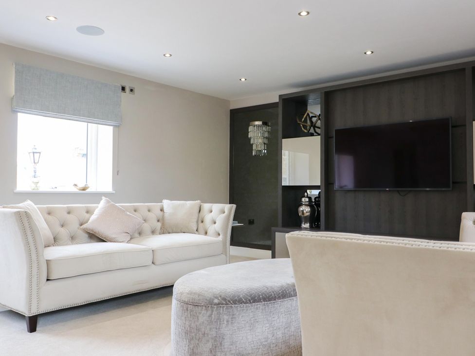 A living room with a sofa and television at Northumberland Luxury Stays - The Chivits near West Chevington