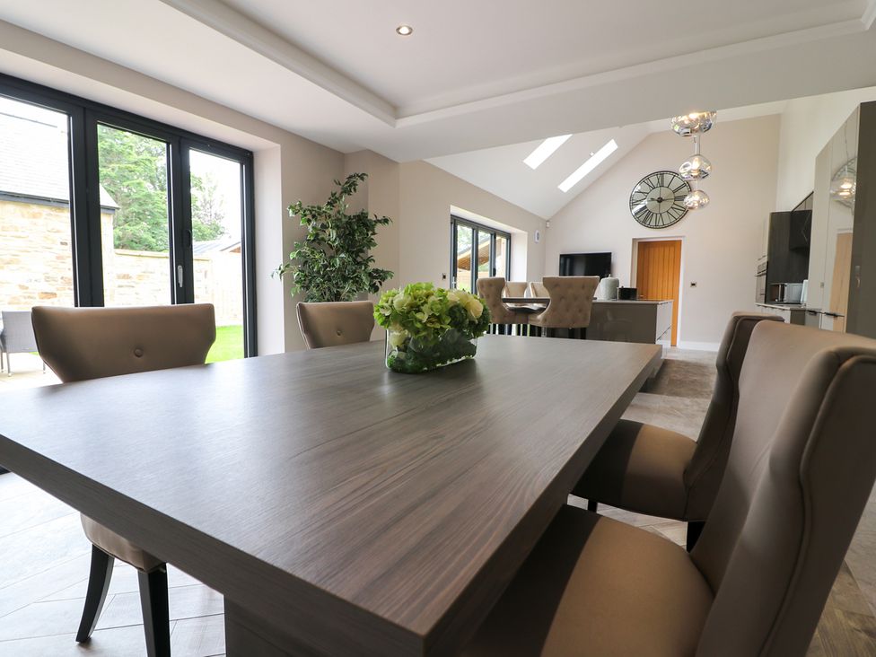 A dining room with a table and chairs at Northumberland Luxury Stays - The Chivits near Amble