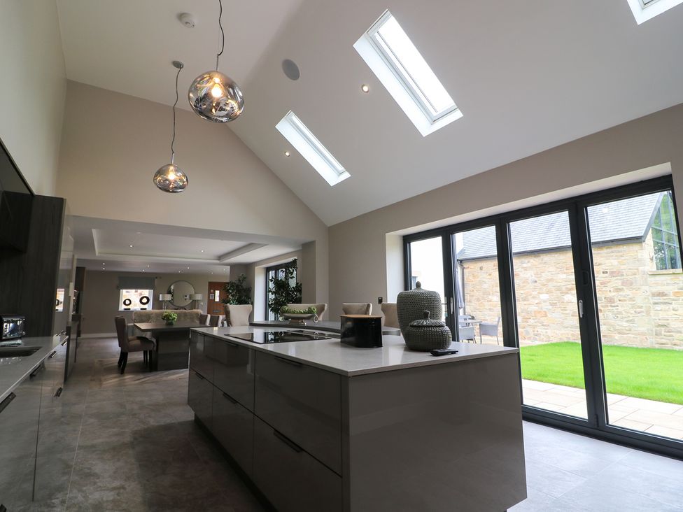 A kitchen with a central island and dining area at Northumberland Luxury Stays - The Chivits near West Chevington