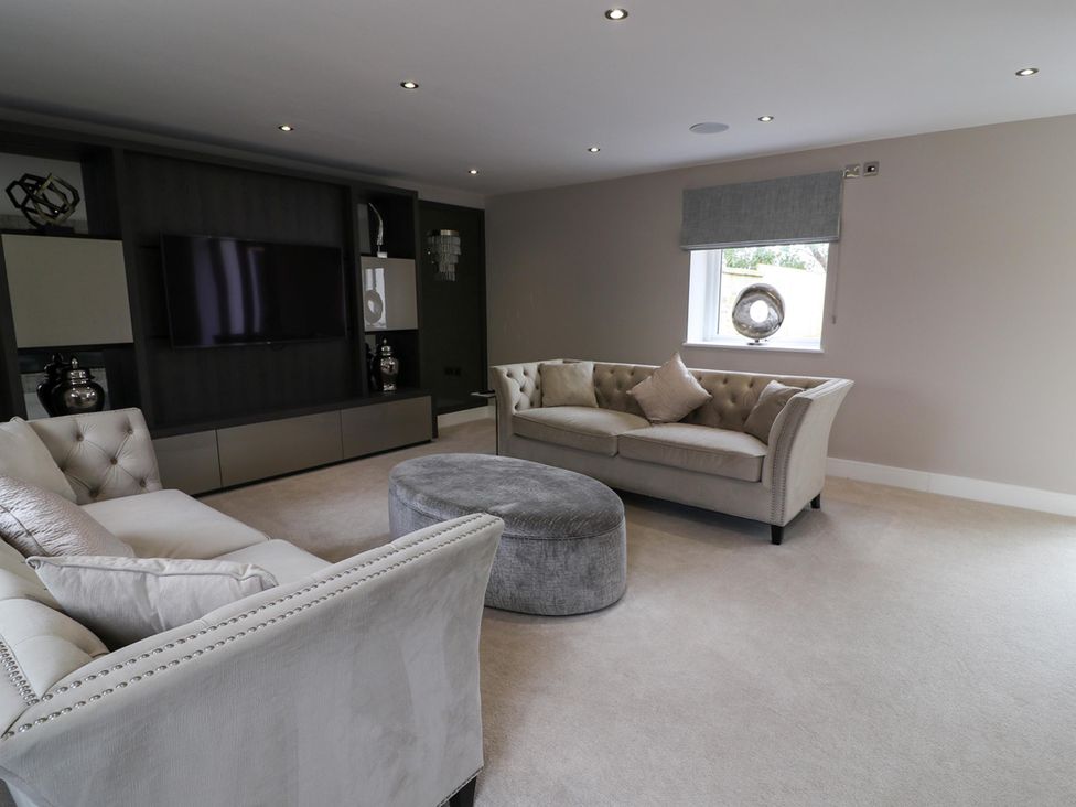 A living room with sofa and television at Northumberland Luxury Stays - The Chivits near Amble