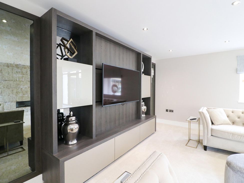 A living room with a television and decorative objects at Northumberland Luxury Stays - The Chivits near Amble
