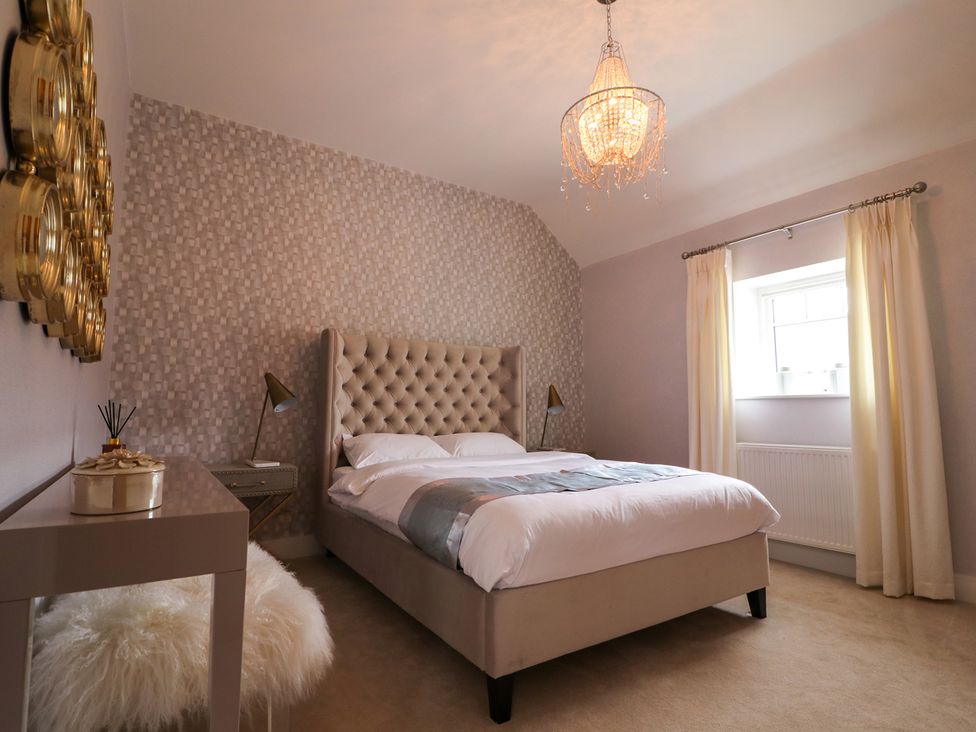 A bedroom with a bed and window at Northumberland Luxury Stays - The Chivits near Amble