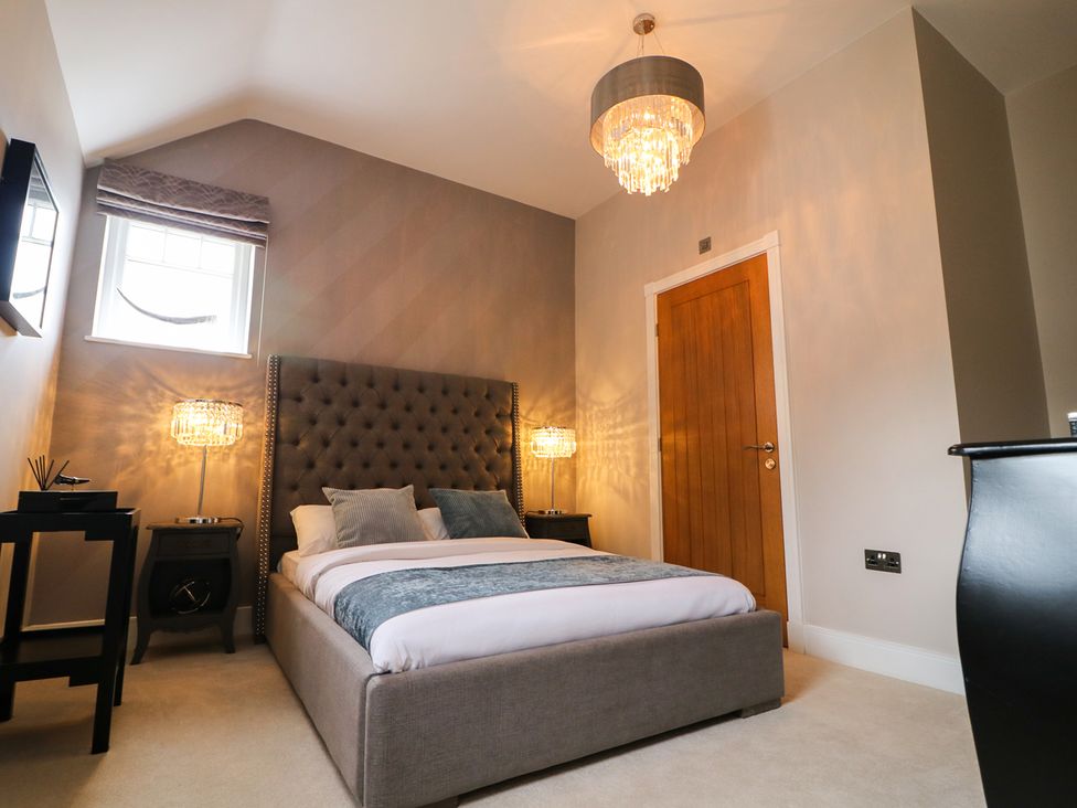 A bedroom with a bed and bedside tables at Northumberland Luxury Stays - The Chivits near Amble
