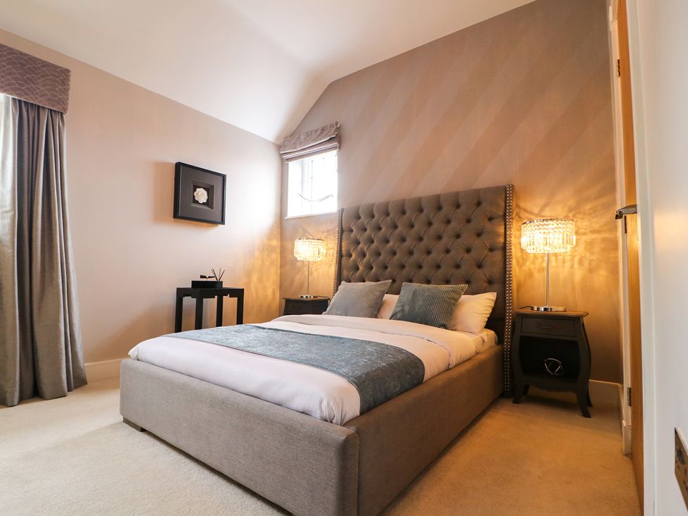 A bedroom with a bed and nightstand at Northumberland Luxury Stays - The Chivits near Amble