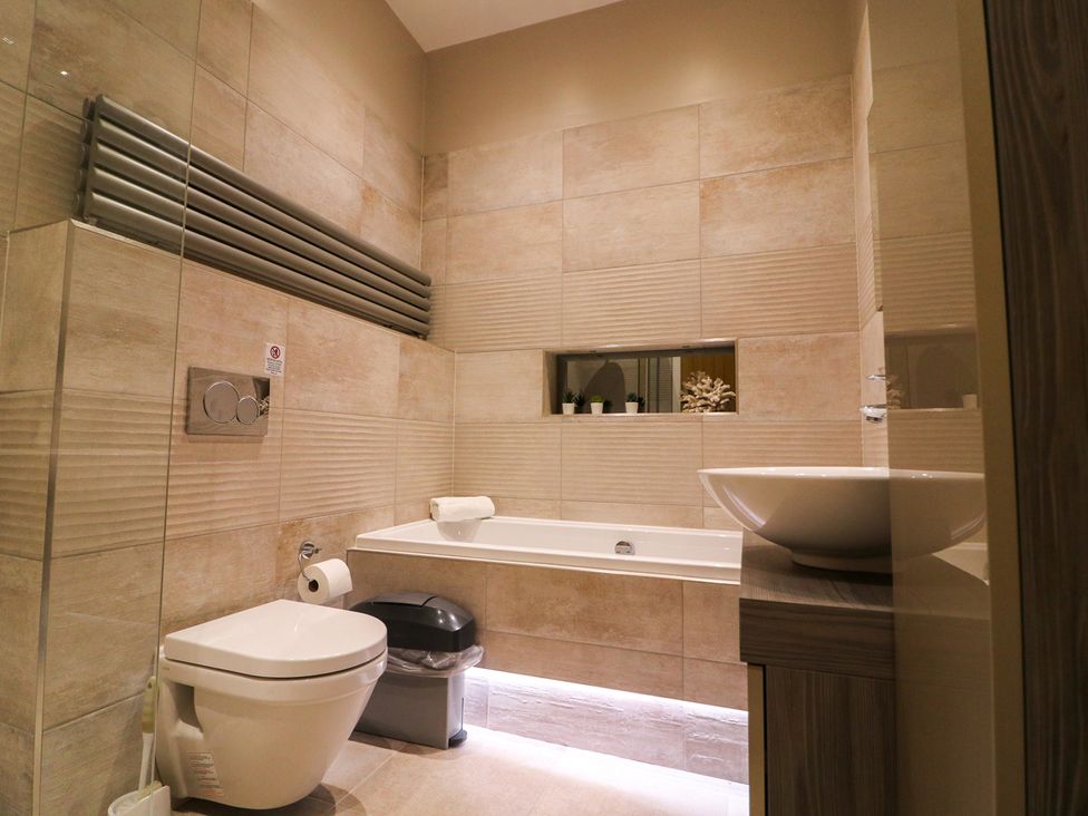 A bathroom with a bathtub and toilet at Northumberland Luxury Stays - The Chivits West Chevington near Amble