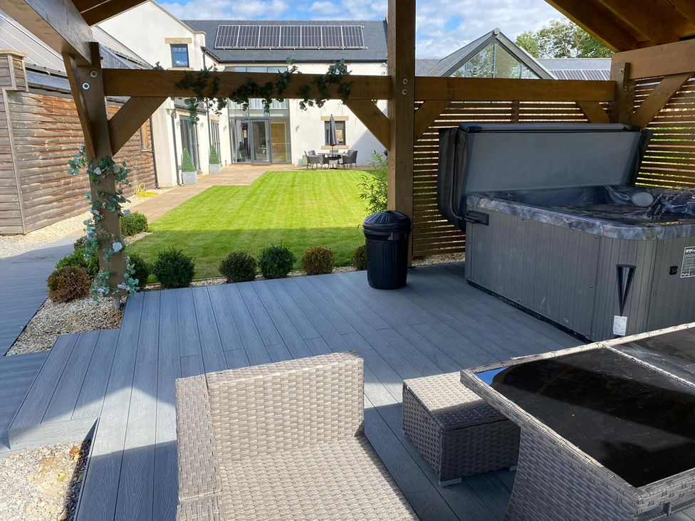 A garden with a hot tub and outdoor seating at Northumberland Luxury Stays - The Chivits near Amble