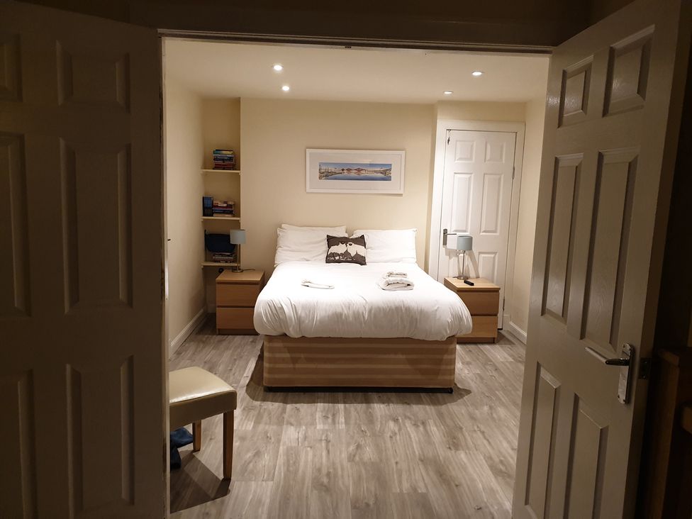 A bedroom with a bed and side tables at Cellardyke 3-Bed House, Sleeps 6 with Sea Terrace in Cellardyke