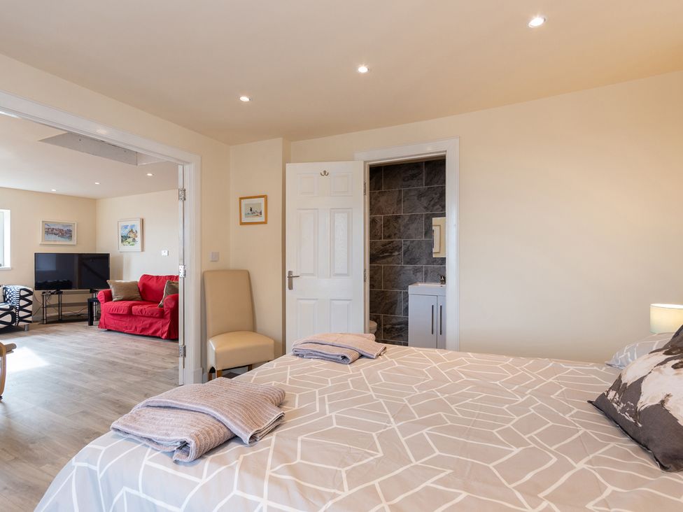 A bedroom with a bed and chair at Cellardyke 3-Bed House, Sleeps 6 with Sea Terrace, Cellardyke