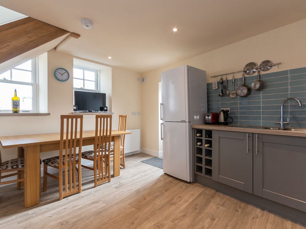 A kitchen with a dining table and chairs at Cellardyke 3-Bed House, Sleeps 6 with Sea Terrace in Cellardyke