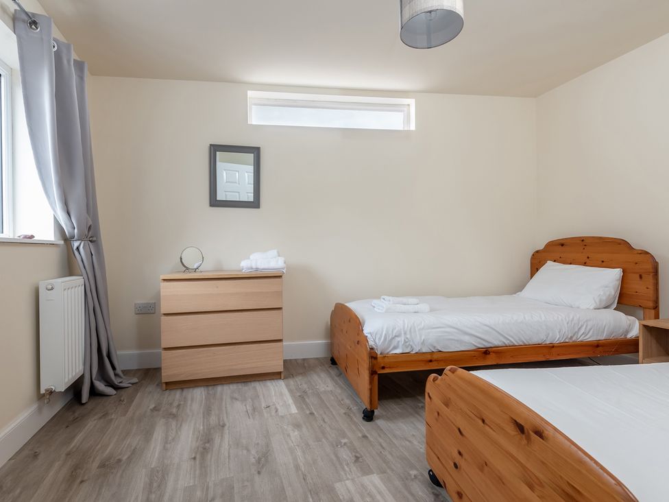 A bedroom with two beds and furniture at Cellardyke 3-Bed House, Sleeps 6 with Sea Terrace, Cellardyke