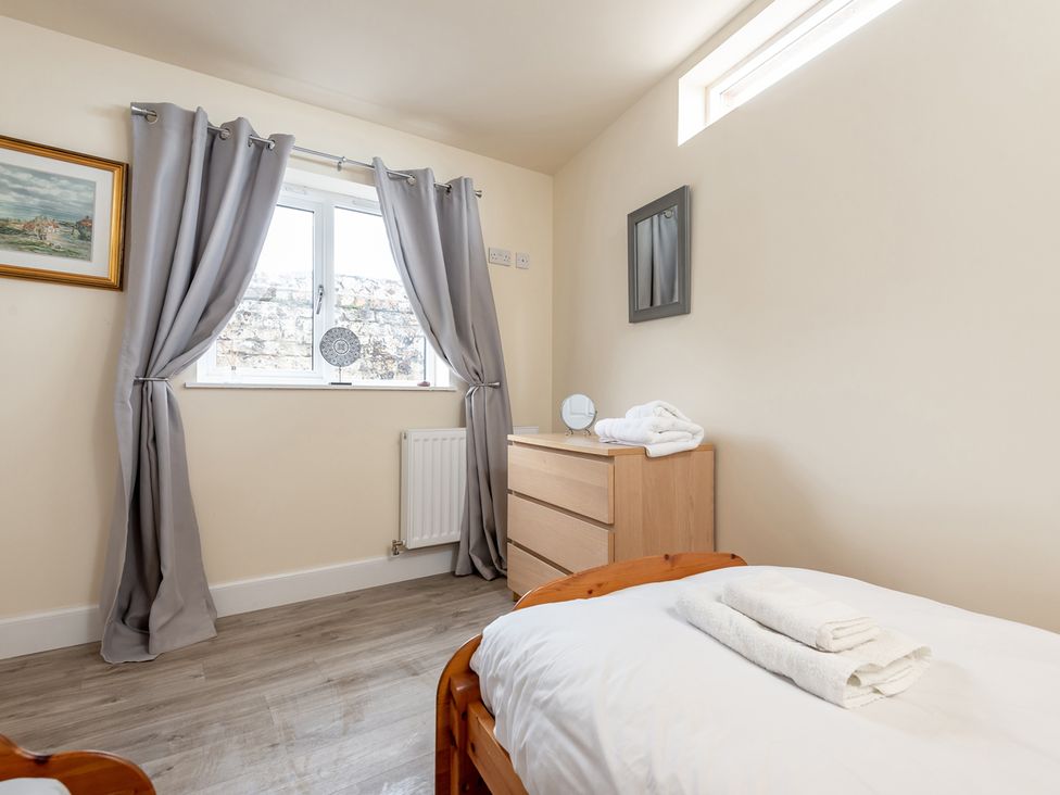 A bedroom with a bed, dresser, and window at Cellardyke 3-Bed House, Sleeps 6 with Sea Terrace, Cellardyke
