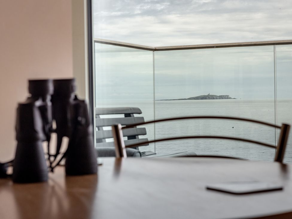 A table with binoculars and a view of the sea at Cellardyke 3-Bed House, Sleeps 6 with Sea Terrace in Cellardyke