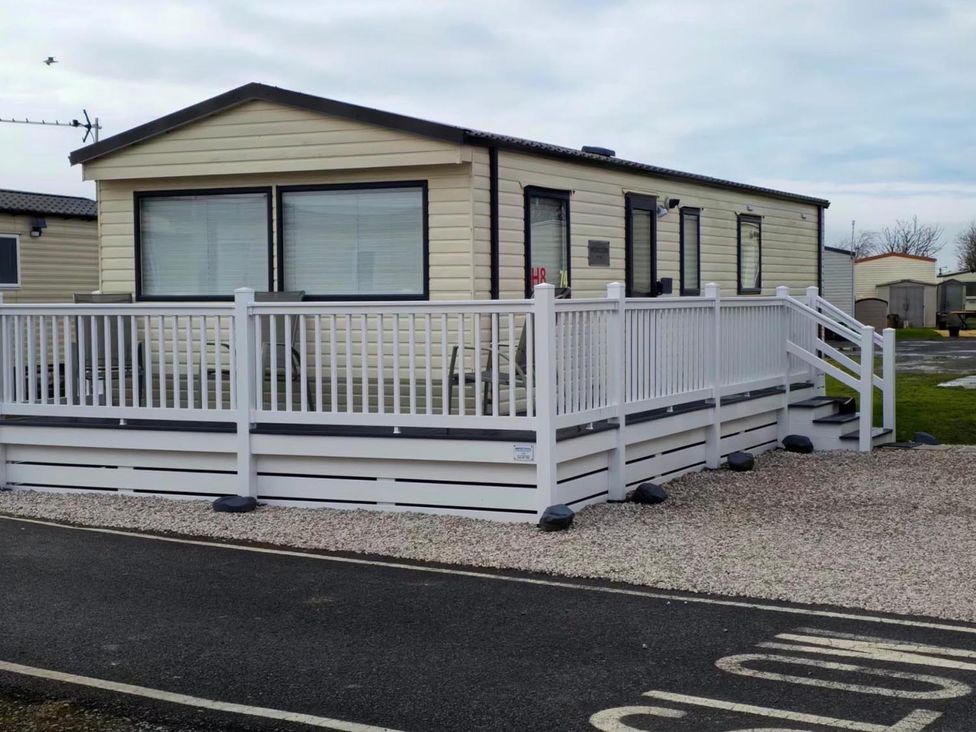 A mobile home with decking and railing at Port Haverigg Cabin Sleeps 4 Steel Green near Haverigg