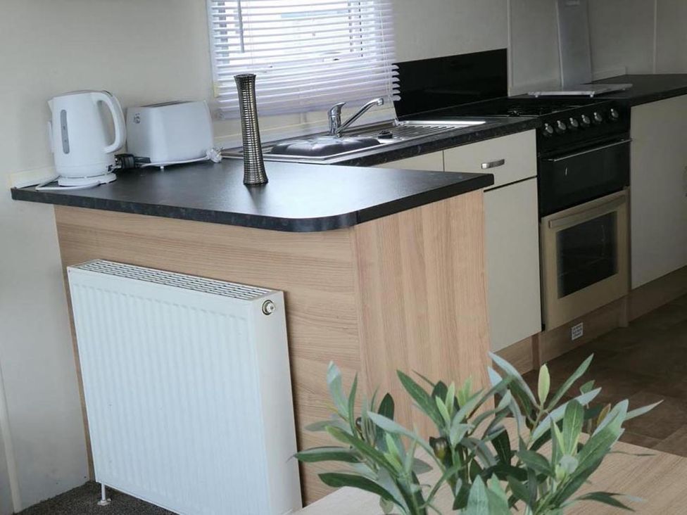 A kitchen with a stove and sink at Port Haverigg Cabin Sleeps 4 Steel Green near Haverigg