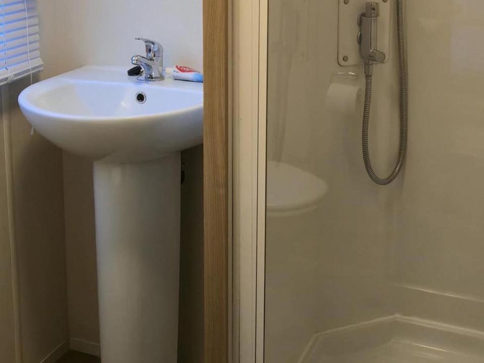 A bathroom with a sink and shower at Port Haverigg Cabin Sleeps 4 Steel Green near Haverigg